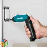 Makita DF001DW cordless screwdriver on project screwing wall